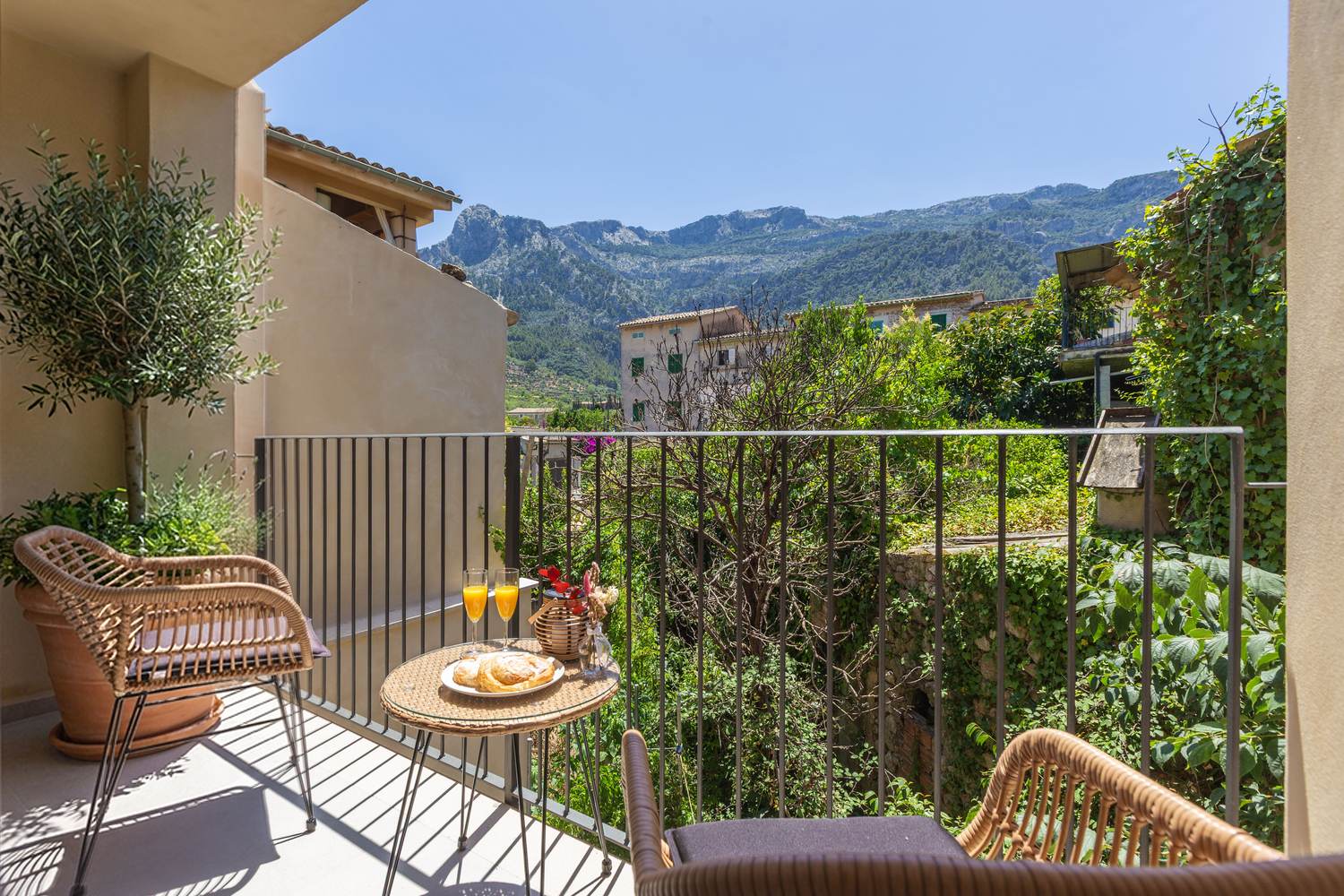 A terrace with a table laid and the Serra de Tramuntana beyond